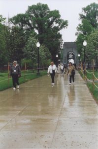 Delegates on rainy walkway